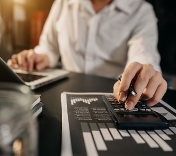 Businesswoman working desk office with using calculator calculate numbers finance accounting concept 18158282 1 360x320